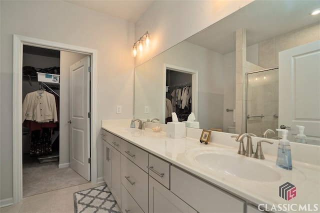 1260 Starboard Way, Greensboro, GA 30642 - bathroom featuring double vanity, a spacious closet, and a stall shower