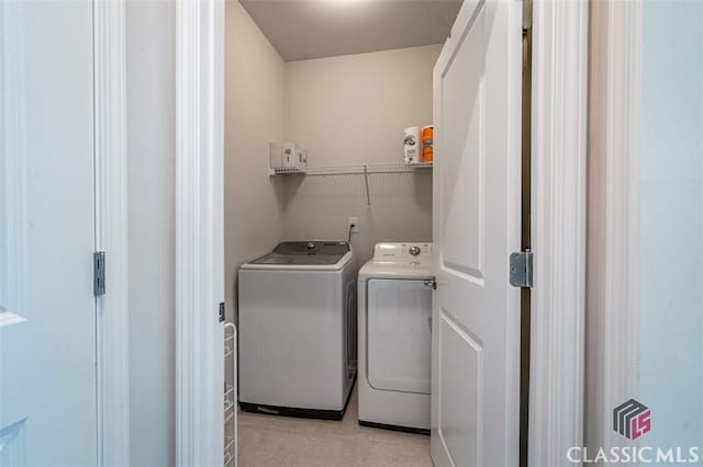 1260 Starboard Way, Greensboro, GA 30642 - laundry room with washing machine and dryer and light tile patterned floors