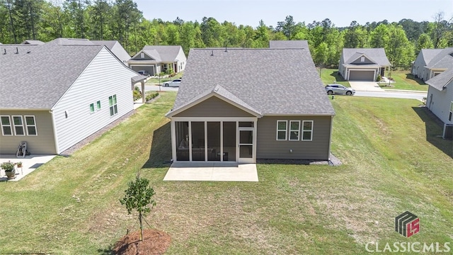 1260 Starboard Way, Greensboro, GA 30642 - rear view of house with a sunroom, a lawn, a patio, and a residential view