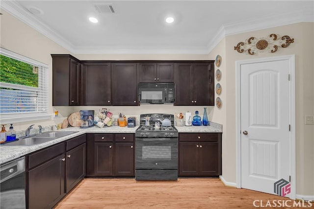 263 Turtle Creek Dr, Winder, GA 30680 - kitchen featuring black appliances, dark brown cabinets, crown molding, and light wood-type flooring