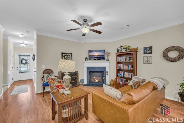 263 Turtle Creek Dr, Winder, GA 30680 - living room featuring ornamental molding, ceiling fan, light wood finished floors, and a fireplace with flush hearth