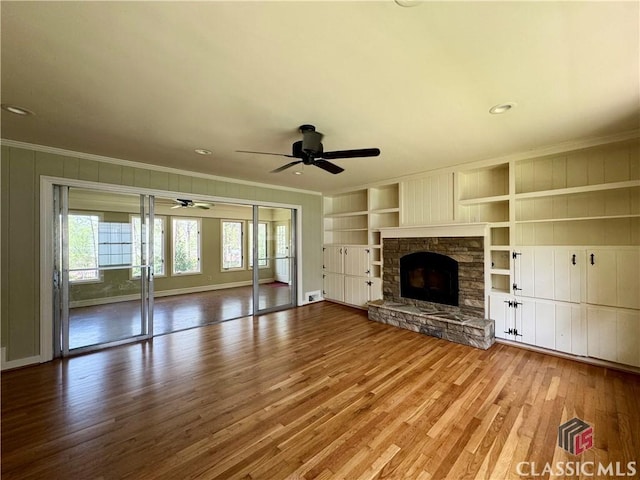 270 Riverhill Dr, Athens, GA 30606 - unfurnished living room with wood finished floors, ornamental molding, ceiling fan, a fireplace, and built in features