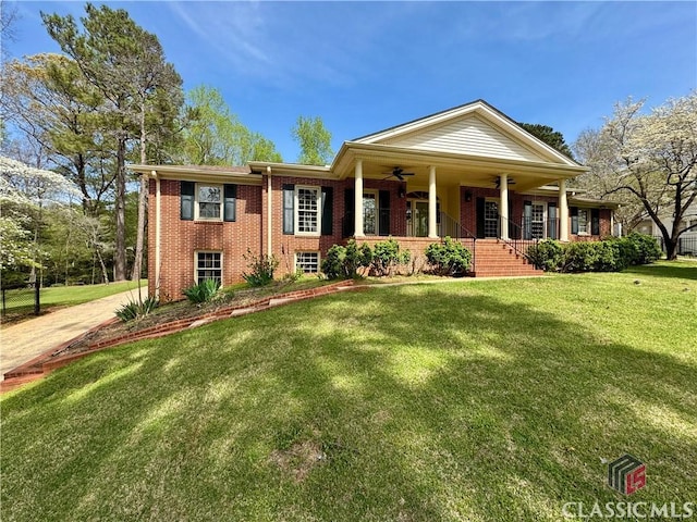 270 Riverhill Dr, Athens, GA 30606 - neoclassical home featuring a ceiling fan, brick siding, a porch, and a front lawn