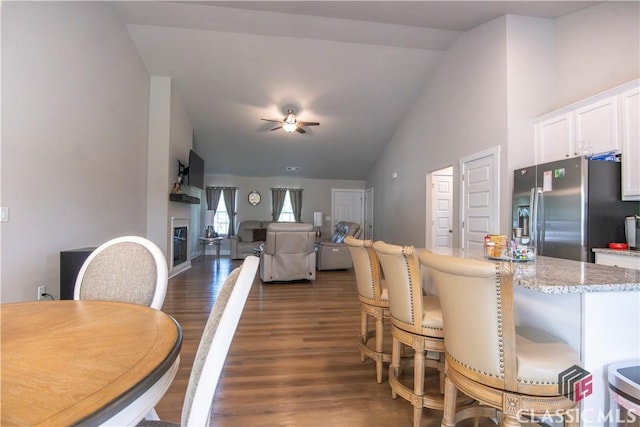 11 Rachel, Hartwell, GA 30643 - dining area featuring vaulted ceiling, a glass covered fireplace, dark wood finished floors, and a ceiling fan