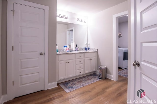 11 Rachel, Hartwell, GA 30643 - bathroom featuring washer / clothes dryer, double vanity, and wood finished floors