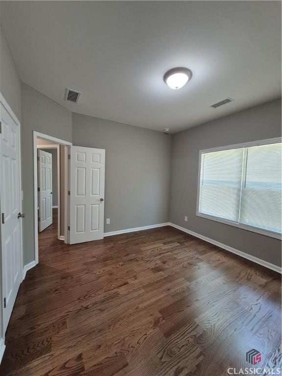 1090 Fox Glen Dr, Watkinsville, GA 30677 - unfurnished bedroom with dark wood-type flooring and baseboards