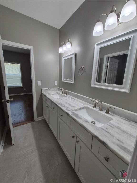 1090 Fox Glen Dr, Watkinsville, GA 30677 - bathroom with double vanity and baseboards