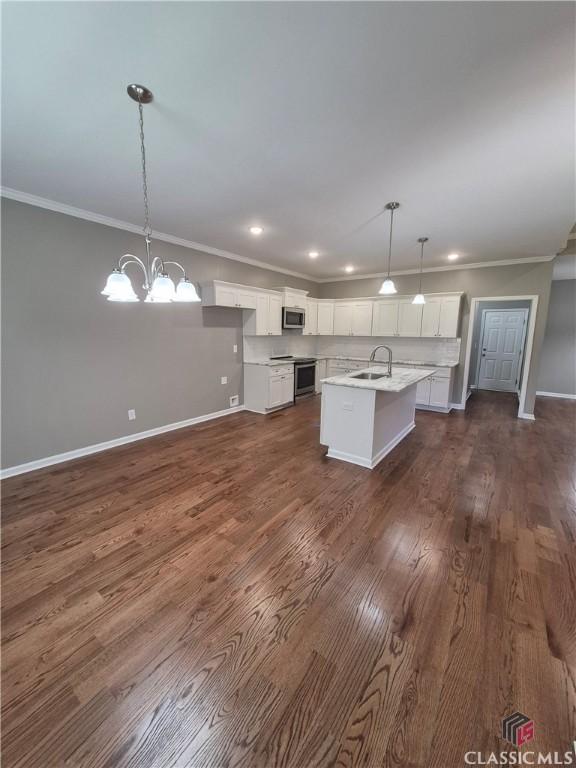 1090 Fox Glen Dr, Watkinsville, GA 30677 - kitchen with appliances with stainless steel finishes, white cabinetry, light countertops, ornamental molding, and a chandelier