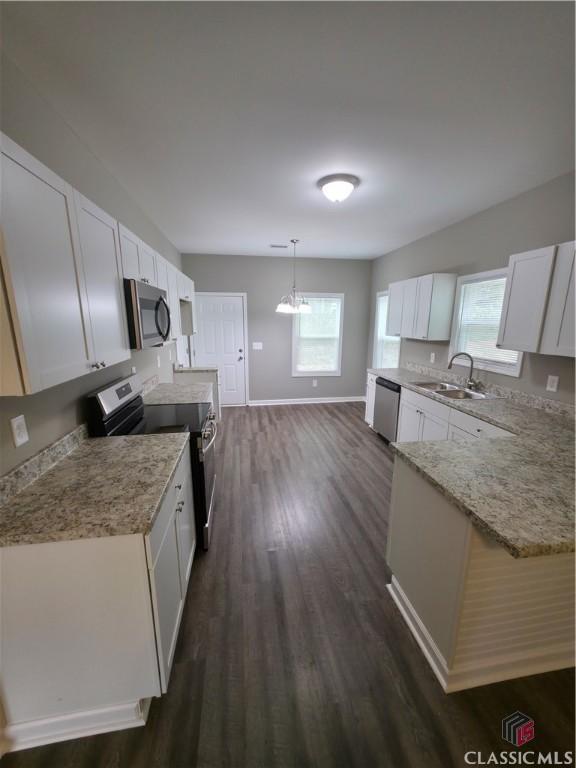 366 Washington Dr, Athens, GA 30601 - kitchen featuring stainless steel appliances, dark wood-style flooring, white cabinetry, and plenty of natural light