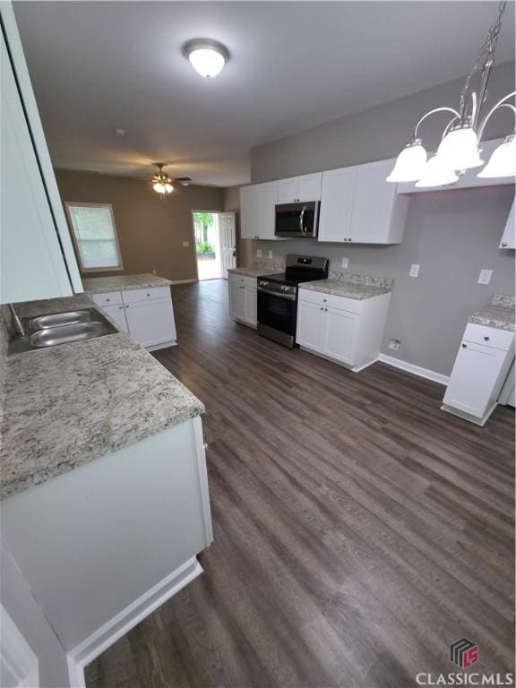 366 Washington Dr, Athens, GA 30601 - kitchen featuring appliances with stainless steel finishes, dark wood-type flooring, white cabinets, and a peninsula