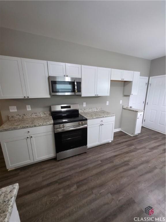 366 Washington Dr, Athens, GA 30601 - kitchen featuring stainless steel appliances, white cabinets, dark wood-style flooring, and light stone counters