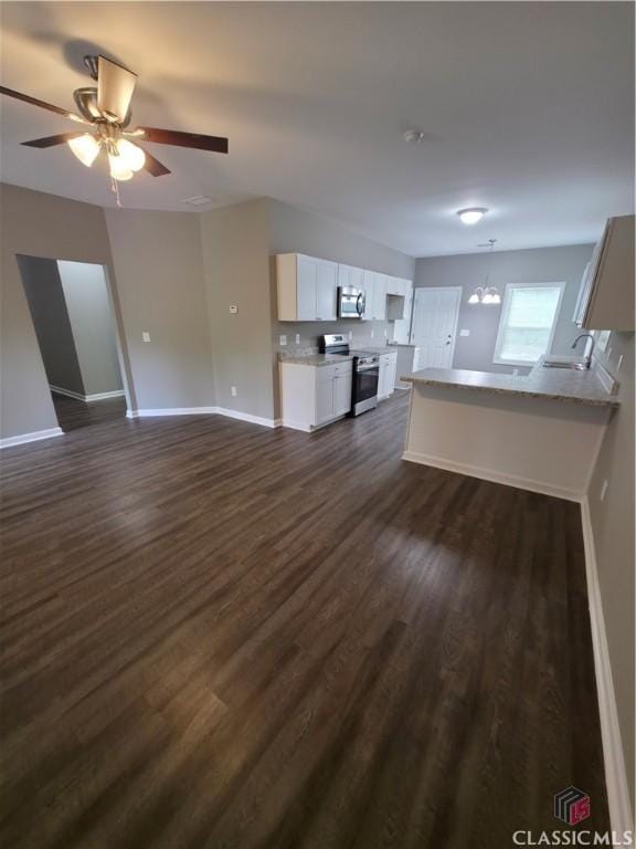 366 Washington Dr, Athens, GA 30601 - unfurnished living room with dark wood-style flooring, ceiling fan, and a chandelier