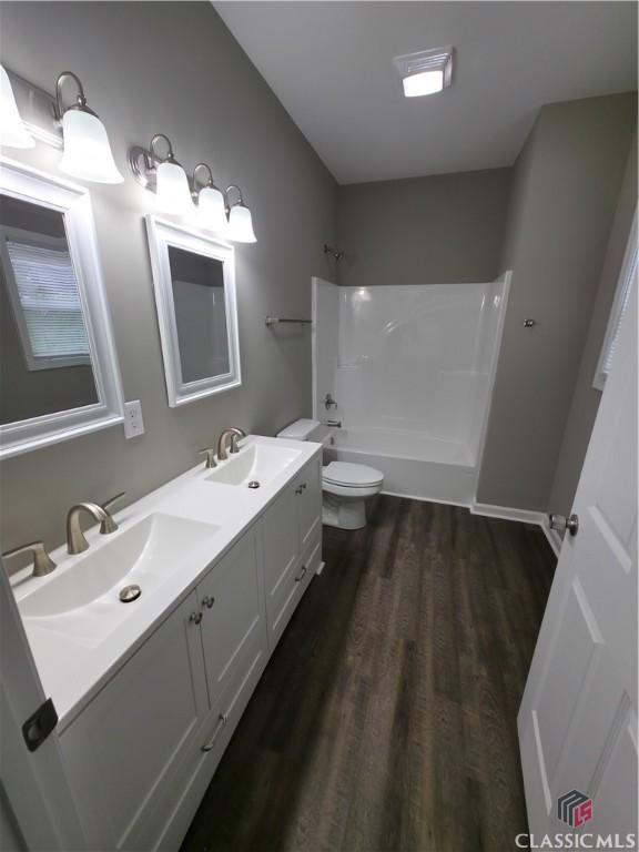 366 Washington Dr, Athens, GA 30601 - full bath featuring double vanity, tub / shower combination, and wood finished floors