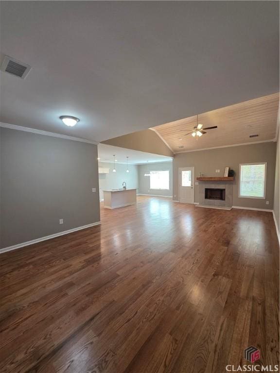 1070 Lane Creek Ter, Bishop, GA 30621 - unfurnished living room featuring plenty of natural light, ornamental molding, dark wood finished floors, a fireplace, and ceiling fan