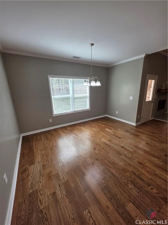 1070 Lane Creek Ter, Bishop, GA 30621 - unfurnished dining area featuring a chandelier, dark wood-type flooring, plenty of natural light, and ornamental molding