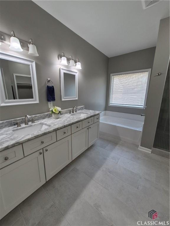 1070 Lane Creek Ter, Bishop, GA 30621 - full bath with double vanity, a garden tub, and tile patterned flooring