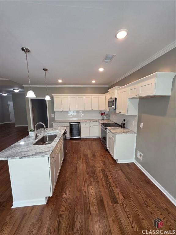 1070 Lane Creek Ter, Bishop, GA 30621 - kitchen featuring stainless steel appliances, white cabinetry, ornamental molding, light stone countertops, and hanging light fixtures