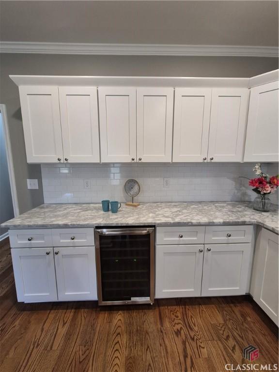 1070 Lane Creek Ter, Bishop, GA 30621 - kitchen featuring wine cooler, white cabinetry, ornamental molding, backsplash, and dark wood-style flooring