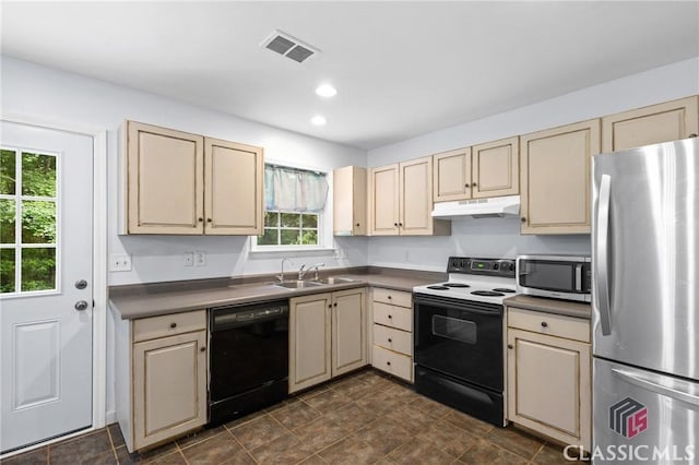 255 Twin Creek Shrs, Athens, GA 30605 - kitchen with black appliances, cream cabinets, under cabinet range hood, dark countertops, and recessed lighting