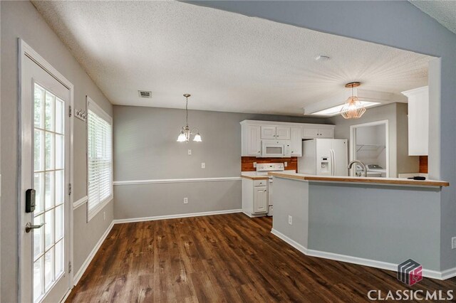 94 Pinewood Cir, Colbert, GA 30628 - kitchen featuring white appliances, dark wood-style floors, white cabinets, pendant lighting, and a textured ceiling