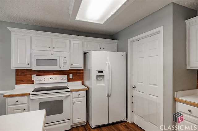 94 Pinewood Cir, Colbert, GA 30628 - kitchen with white appliances, white cabinetry, and dark wood finished floors