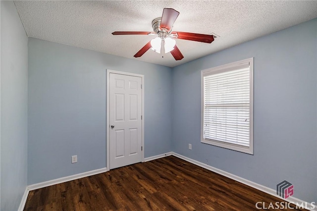 94 Pinewood Cir, Colbert, GA 30628 - spare room featuring dark wood finished floors, a textured ceiling, and ceiling fan