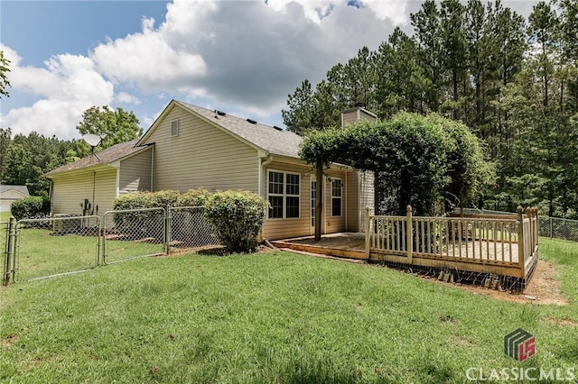 94 Pinewood Cir, Colbert, GA 30628 - rear view of house with a wooden deck, a gate, and a chimney