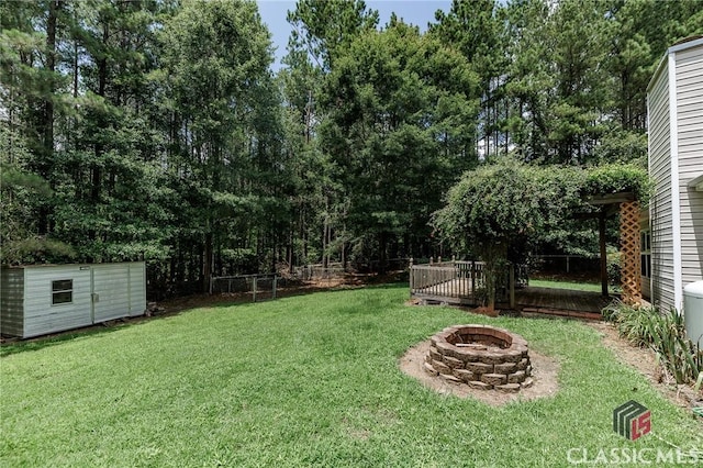 94 Pinewood Cir, Colbert, GA 30628 - view of yard with an outdoor fire pit and a storage shed