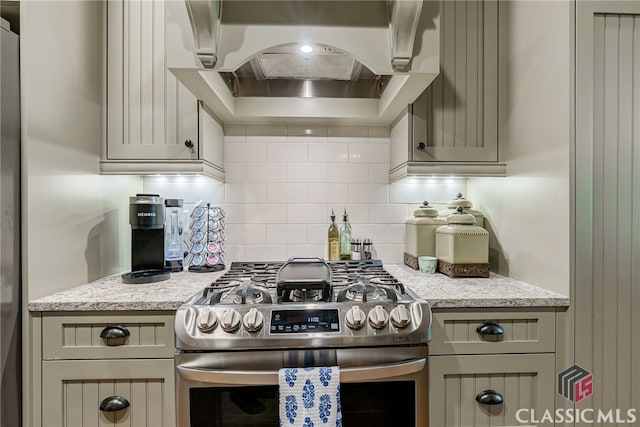 1640 Madison Ct, Bogart, GA 30622 - kitchen with stainless steel gas range, exhaust hood, tasteful backsplash, and light stone countertops