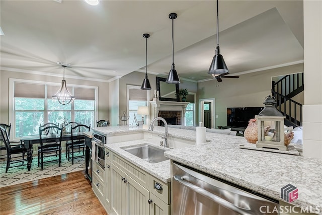 1640 Madison Ct, Bogart, GA 30622 - kitchen featuring stainless steel dishwasher, light wood-style flooring, crown molding, decorative light fixtures, and light stone counters