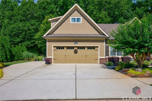 1640 Madison Ct, Bogart, GA 30622 - craftsman-style home with brick siding, board and batten siding, concrete driveway, a garage, and a shingled roof