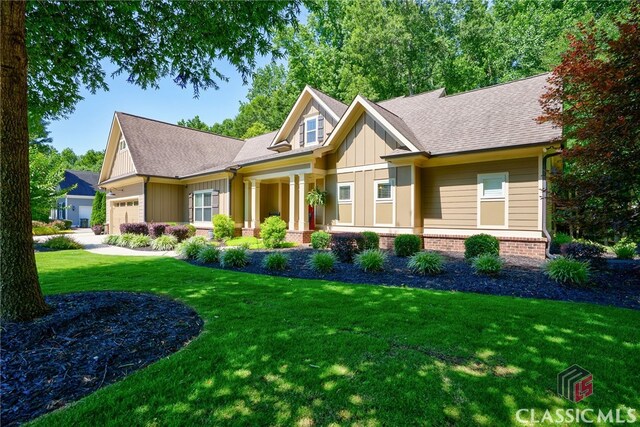 1640 Madison Ct, Bogart, GA 30622 - craftsman-style home featuring board and batten siding, a front lawn, a garage, and a shingled roof