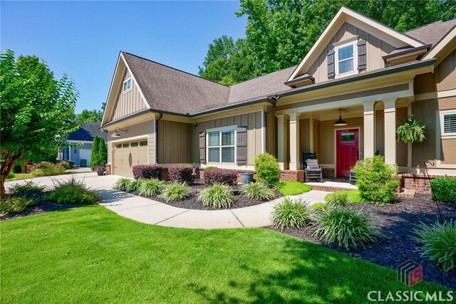 1640 Madison Ct, Bogart, GA 30622 - craftsman house with covered porch, board and batten siding, a front lawn, and driveway