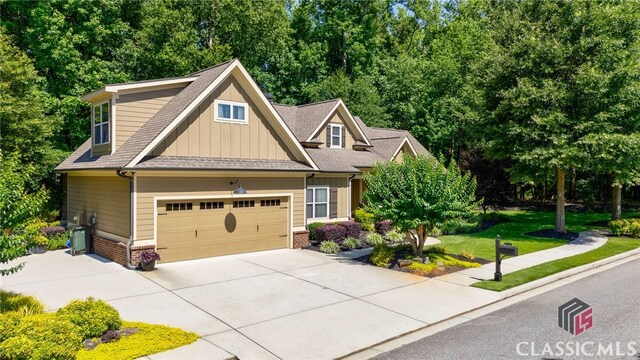 1640 Madison Ct, Bogart, GA 30622 - craftsman-style home featuring board and batten siding, driveway, brick siding, a front yard, and roof with shingles