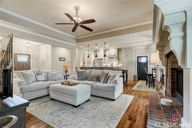 1640 Madison Ct, Bogart, GA 30622 - living area with wood finished floors, ceiling fan, crown molding, and a fireplace