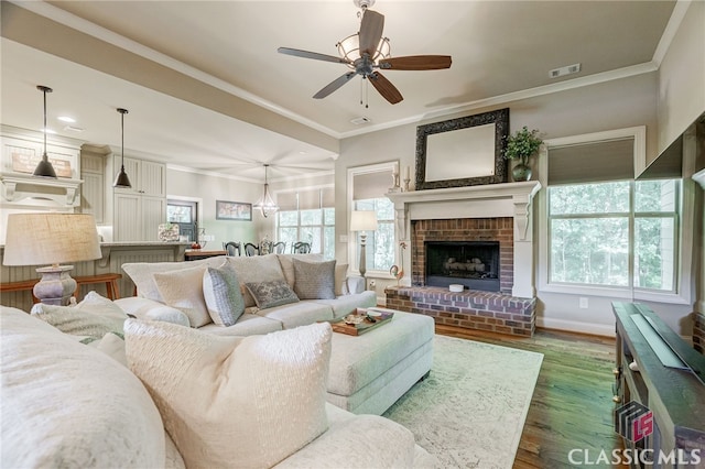 1640 Madison Ct, Bogart, GA 30622 - living area with dark wood finished floors, ceiling fan, ornamental molding, recessed lighting, and a brick fireplace