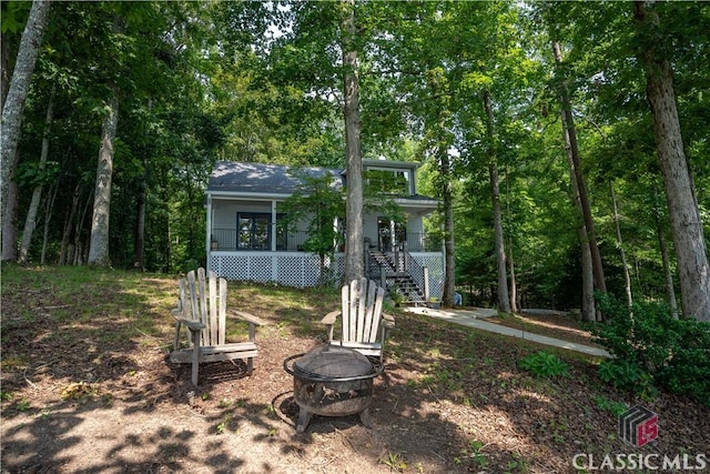 2061 Sugar Creek Trl, Buckhead, GA 30625 - view of front facade with a fire pit, stairway, and covered porch