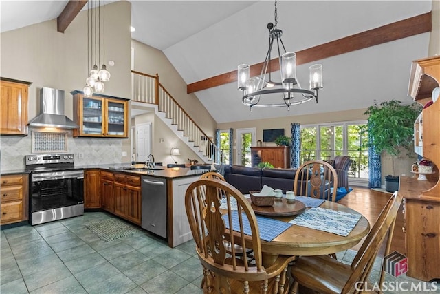 2061 Sugar Creek Trl, Buckhead, GA 30625 - kitchen with stainless steel appliances, wall chimney exhaust hood, a chandelier, high vaulted ceiling, and dark countertops