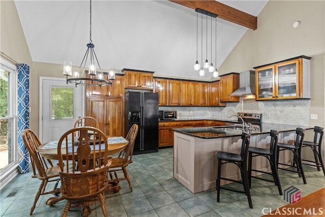 2061 Sugar Creek Trl, Buckhead, GA 30625 - kitchen featuring black refrigerator with ice dispenser, wall chimney exhaust hood, brown cabinets, decorative backsplash, and a chandelier