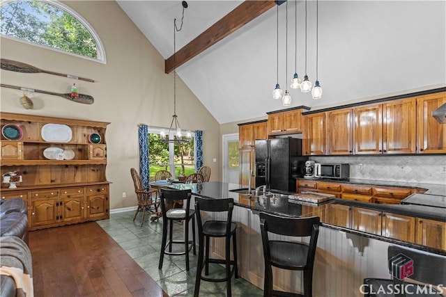 2061 Sugar Creek Trl, Buckhead, GA 30625 - kitchen with high vaulted ceiling, black refrigerator with ice dispenser, stainless steel microwave, brown cabinetry, and tasteful backsplash
