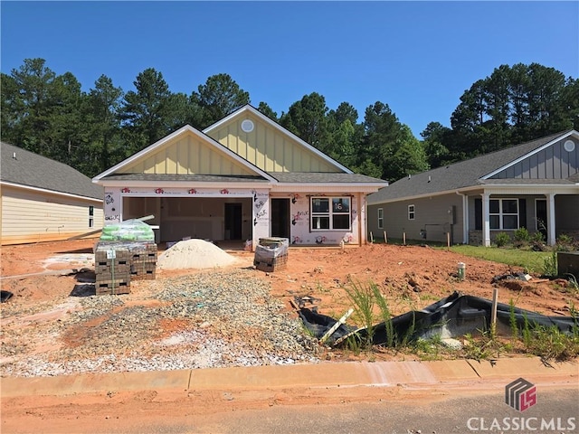 51 Charlie Way, Winder, GA 30680 - view of front of property with board and batten siding and an attached garage