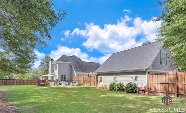 1105 Harperfield Dr, Bogart, GA 30622 - back of house featuring a fenced backyard, a chimney, and a shingled roof