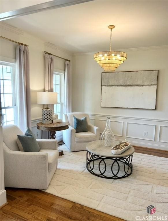1105 Harperfield Dr, Bogart, GA 30622 - living room featuring crown molding, wood finished floors, a chandelier, and a wainscoted wall