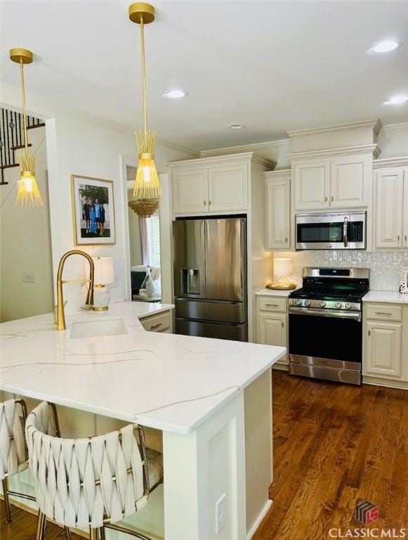 1105 Harperfield Dr, Bogart, GA 30622 - kitchen with stainless steel appliances, light stone countertops, dark wood-type flooring, pendant lighting, and crown molding