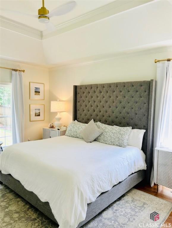 1105 Harperfield Dr, Bogart, GA 30622 - bedroom featuring multiple windows, crown molding, a tray ceiling, wood finished floors, and a ceiling fan