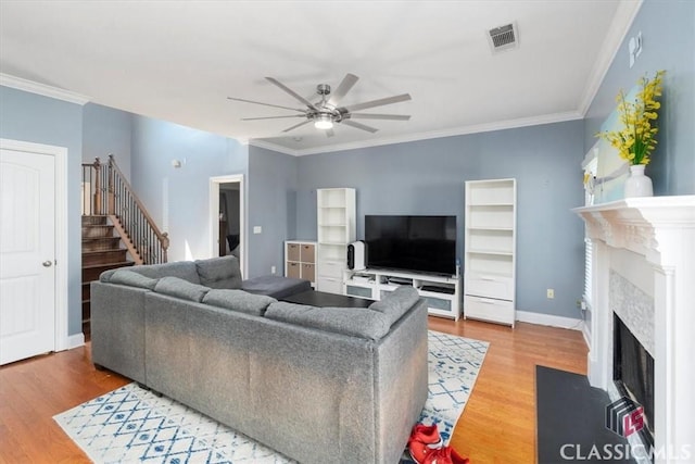 232 Township Ln, Athens, GA 30606 - living area featuring a ceiling fan, wood finished floors, a premium fireplace, stairway, and crown molding