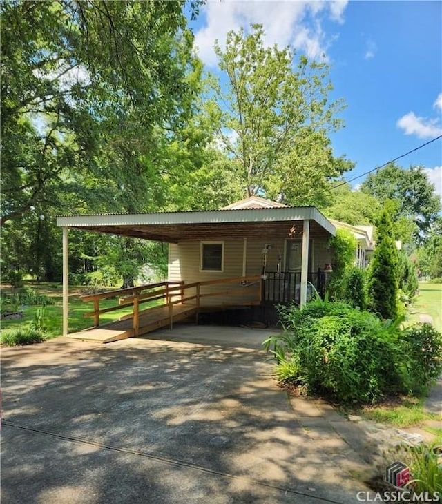 4660 Fairplay Rd, Madison, GA 30650 - view of front facade with concrete driveway and a carport
