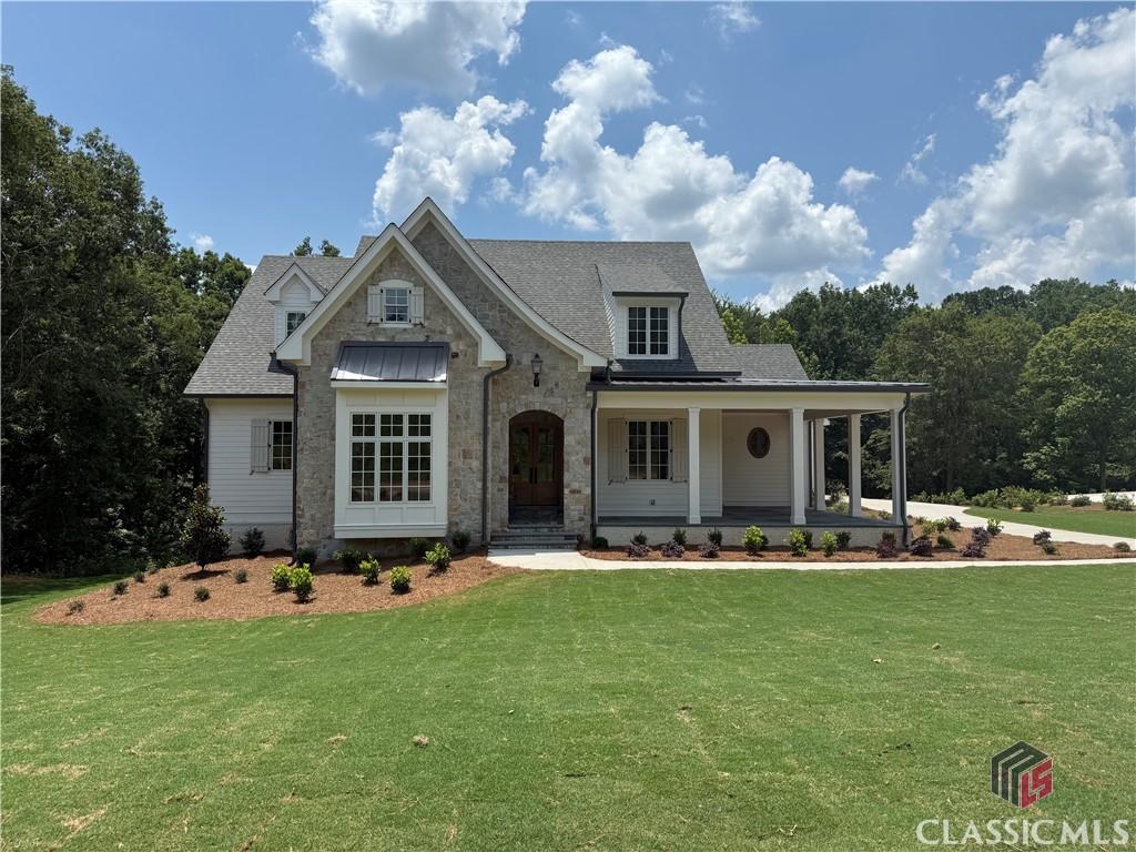 1538 Athena Way, Athens, GA 30606 - view of front facade with a front yard, stone siding, and a porch
