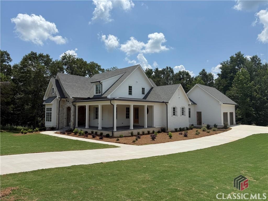 1538 Athena Way, Athens, GA 30606 - modern farmhouse style home featuring covered porch, a front lawn, an attached garage, and driveway