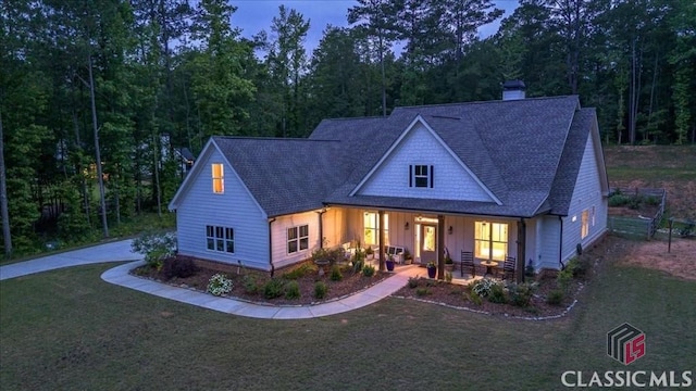 1069 Dean Hill Rd, Monroe, GA 30655 - view of front facade featuring board and batten siding, a chimney, a front yard, and a shingled roof